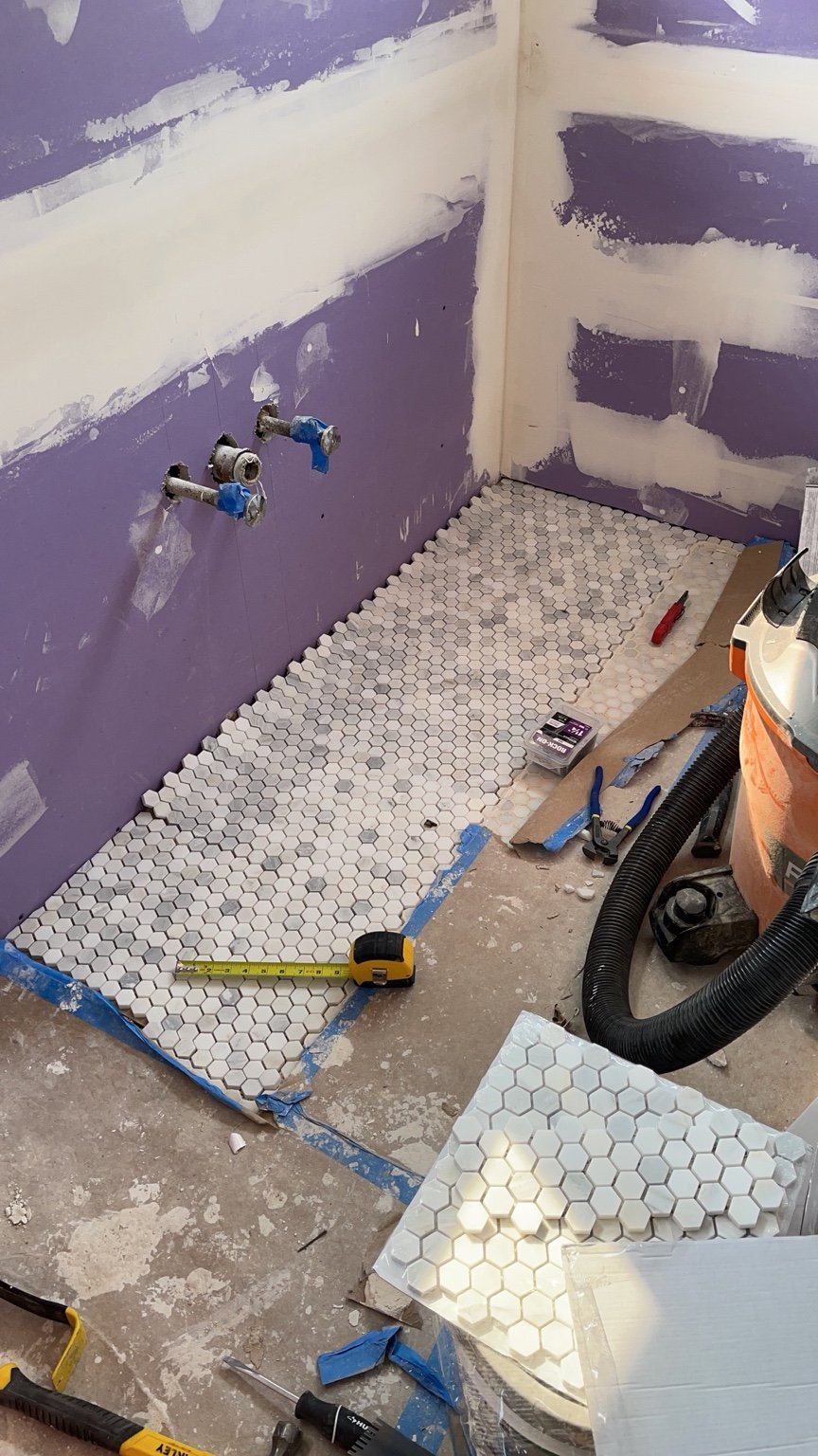 Bathroom floor tile installation in progress