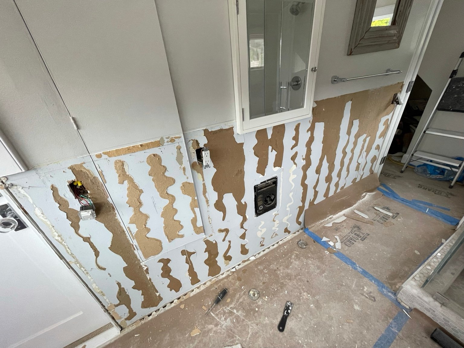 Bathroom wall and vanity removal in progress